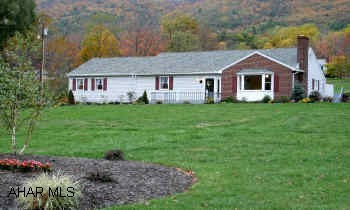 Lovely Ranch Home on 1.13 acres, professionally landscaped, El Dorado stone accents, wood fireplace in living room, front and rear deck, carport, oversized two car garage. All freshly painted thru-out, raised perennial flower bed.