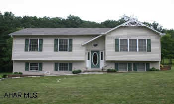 Striking Brick/Vinyl Raised Ranch home located on 1.34 acres in great neighborhood. Quiet street; large yard w/fenced play area and stone edged garden. Woodland views from back deck. Near schools. 2-car garage. Carpet, vinyl, laminate flooring.