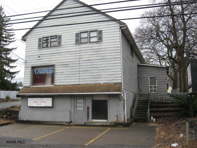 Basement - 3 offices and 1/2 bath.  Second level - 8 rooms and both, Tan Salon.  Third level - was two, three room and bath apartments. Rear paved parking.