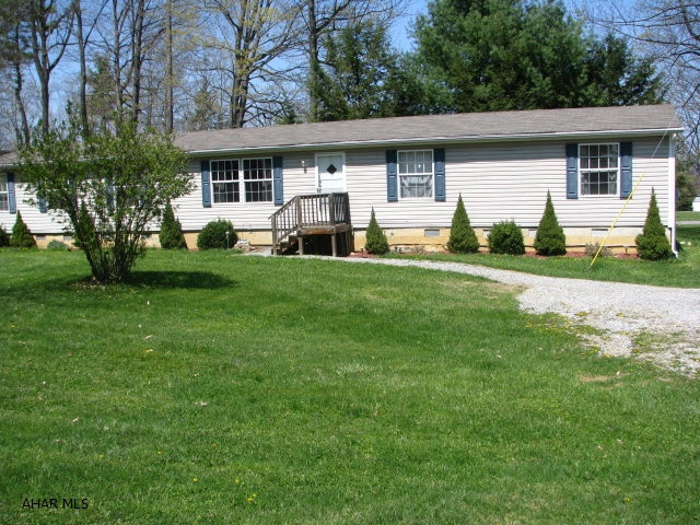 Beautiful setting between Altoona and Bellwood.  This may be titled a doublewide but it is truly a very large home.  Open concept living, dining and kitchen area.  Large Master with bath and a closet the size of some bedrooms! Closets in the other three large bedrooms are sizeable also.    This home sits on just over three quarters of an acre. Along with all the storage upstairs it also has a partial basement. Also with the home there are two sheds and a play house.
