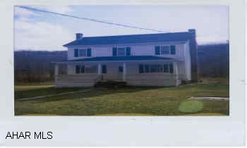 Exterior has newer roof, siding & windows.  Interior needs some finishing.  To be sold "As Is."  Additional lot suitable for building or Mobile Home.