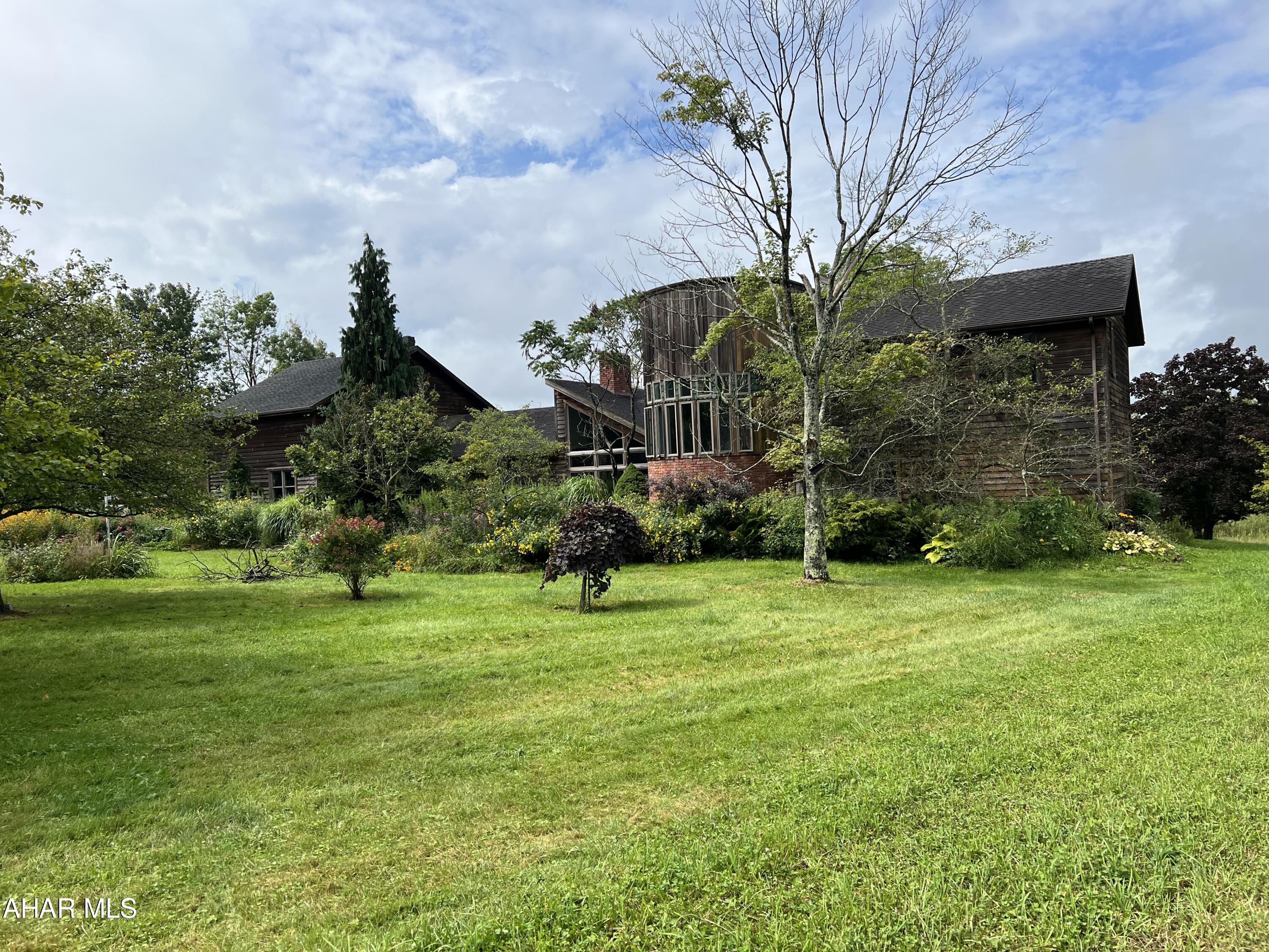 Unbelievable find!!  Surrounded by game lands on two sides  - 50 acre horse farm featuring an over 5000 sq ft house built in 1992, horse barn with 5 stalls, half bath, tack room, heated entry room etc., 3 stall barn with equipment storage, run in sheds, pond and board fenced pastures. The home contains 3 bedrooms 3.5 baths, large living room with vaulted ceiling, fireplace and hardwood floor, dining room, kitchen with custom cabinets, hot tub room with windows showing the view, master bedroom with large full bath off, custom spiral stairway, large art room, partially finished basement with double fireplace, large game room and bath. Too much to list. Home does need some tlc in some areas.  Approx 1/4 mile lane through the woods gives sense of peace entering the property.