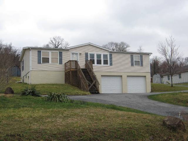 This 3 bedroom, 1 and 3/4 bath doublewide home on a full foundation features an open floor plan with cathedral ceilings, skylights, enclosed back porch, 2-car integral garage, circular black top driveway and wonderful views of the surrounding mountains.  Just minutes from town!