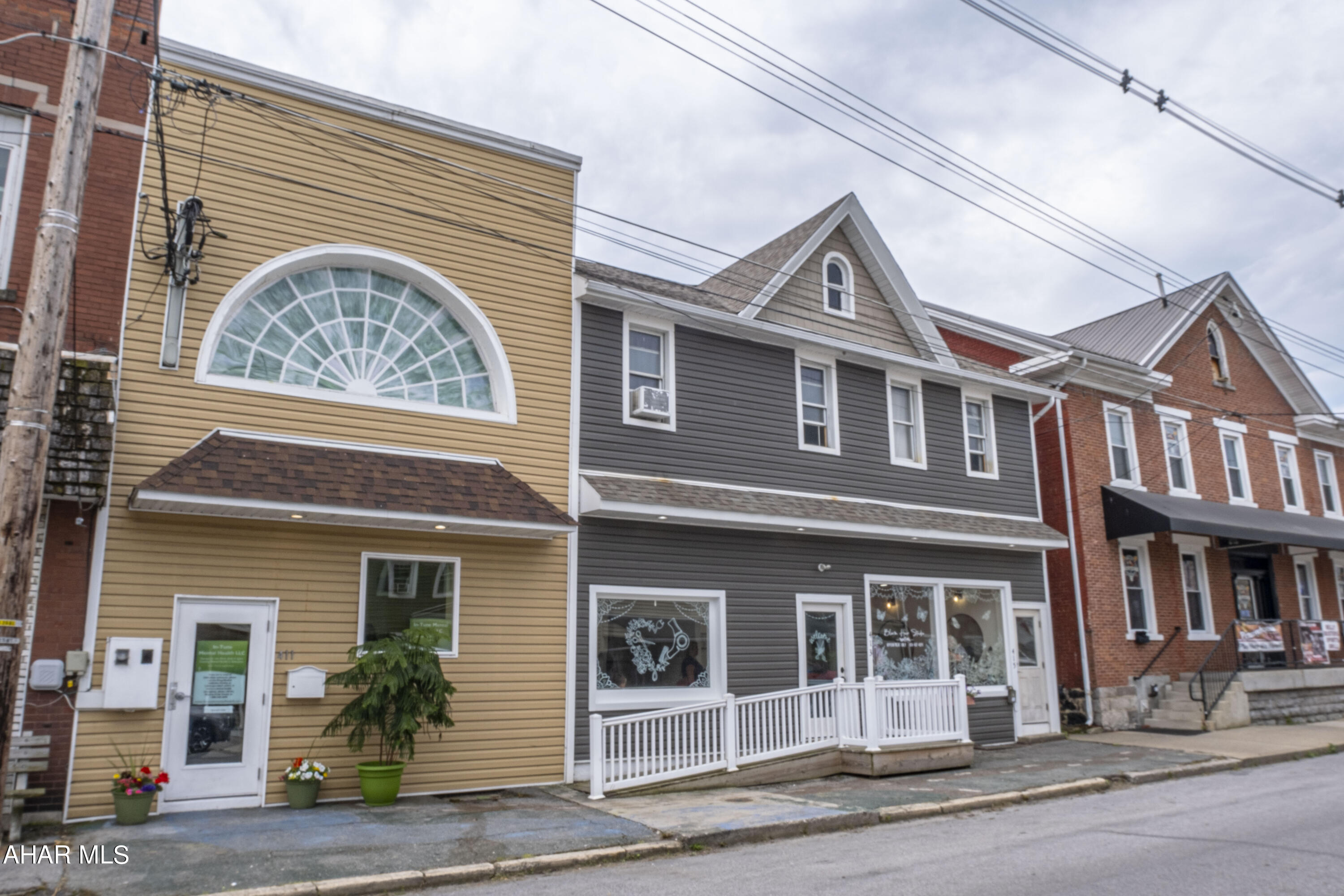 Don't miss this opportunity to own a prime multi-unit investment property! This building includes two distinct units: Unit 1 is a business office (approx. 2000 sq. ft.) complete with a conference room and waiting area, while Unit 2 is a full-service hair salon (approx. 1104 sq. ft.). The second floor features a spacious apartment unit (approx. 2000 sq. ft.) that is currently leased. Additionally, there is an open unit (approx. 1587 sq. ft.), perfect for converting into apartments or additional commercial space. Each unit has its own entrance, and the building is handicap accessible with both a private parking lot and off-street parking.