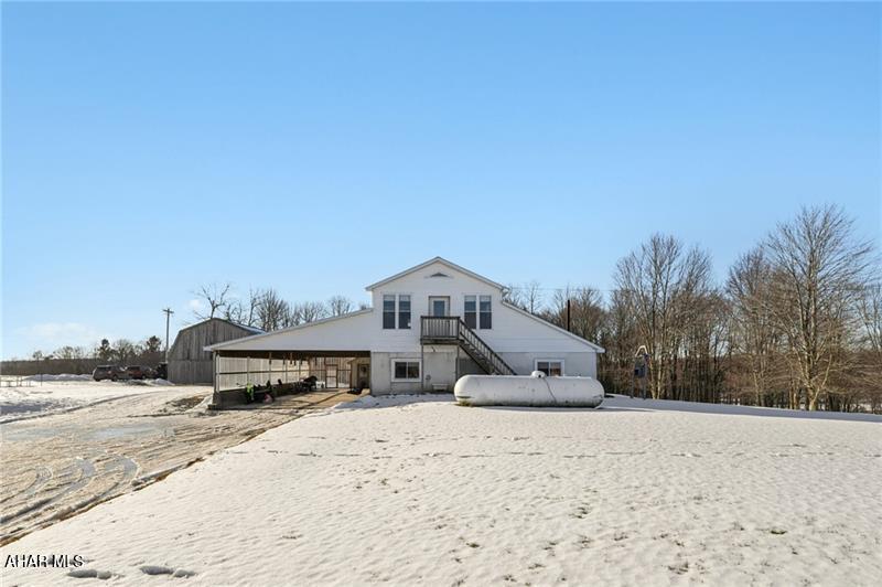 Looking for your space in the country?... This ONE has plenty of it and is located just over a mile from the State Game Lands!  The home is over 5,500 SF and sits on 4 acres of flat land. It could be used as one massive home, keep part of it as a mother-in-law suite, or even live in one side and rent the other as a duplex. It's currently configured as two sides with each having a kitchen with pantry, living room, four bedrooms, and two baths as shown on the floorplans. There's also a large office and a laundry room. Walking inside you'll notice the solid construction and more recent updates throughout. The wood burners provide amazing warmth this time of year with supplemental propane heat if desired. There's a large carport that could easily be finished into an attached garage and the existing detached barn offers plenty of utility for animals or general storage.