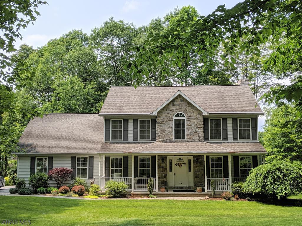CRESSON TWP- Stunning home on corner lot in Cresson Township, featuring a large front yard, mature trees, flowers and greenery that create a colorful scene in Spring & Summer. Entertain on the spacious stone patio out back, accented with a koi pond. The expansive front porch invites you in to sit and relax. Just inside the front door, high ceilings greet you in the foyer, with a lovely dining room to your left and a cozy den to the right. The open concept kitchen/living room features a custom tiled gas fireplace. Downstairs, a fantastic stone accented bar and fireplace highlight the family room. The spacious master suite offers a luxury bath with soaking tub and an extended walk in closet that provides plenty of storage. Three more bedrooms, a full bath, laundry & 2 car garage too!
