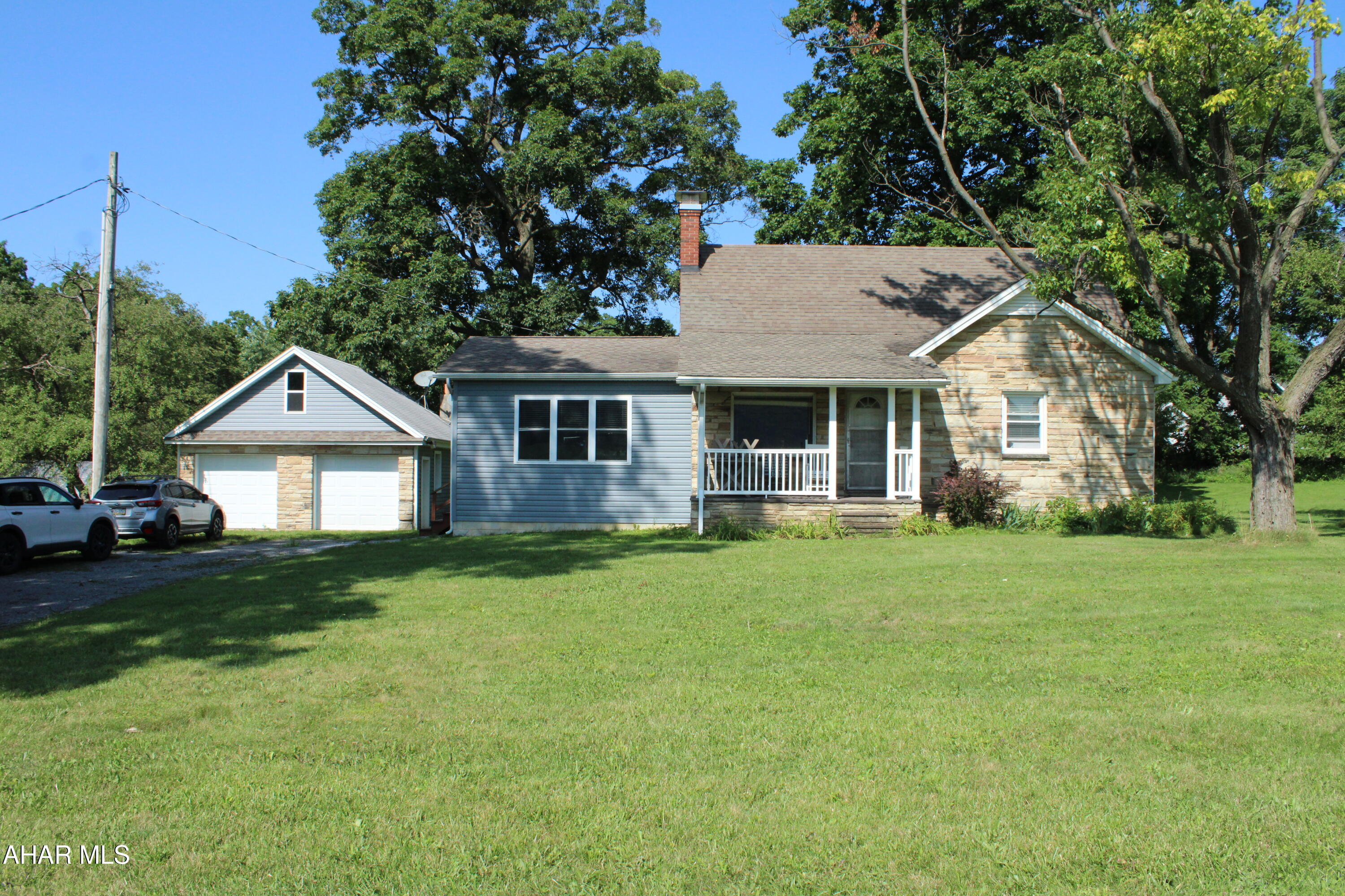 Welcome home to peaceful country living in the beautiful Sinking Valley area! Situated on nearly an acre (0.97 acres), this charming 3-bedroom, 1-bath home offers scenic views and the perfect blend of comfort and tranquility.

Start your mornings or unwind in the evenings on the covered front porch, where rocking chairs and breathtaking countryside views create the perfect place to relax. Inside, you'll find a spacious kitchen featuring durable Corian countertops and plenty of room for cooking, gathering, and entertaining.

The home also has an oversized laundry room with an abundance of storage, making organization a breeze. A detached 2-car garage provides additional space for vehicles, hobbies, or extra storage.

Whether you're looking for your first home, a peaceful retreat, or simply a place to enjoy the beauty of the Sinking Valley countryside, this property offers the space, views, and charm you've been searching for.