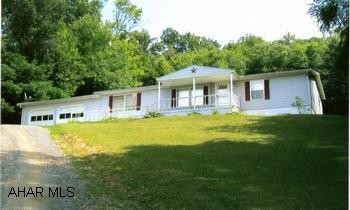 Well maintained doublewide. Includes kitchen appliances (4 years old). New roof and front porch. Roofed patio brightens this shuttered 3BR/2BA home on 1.07 acres. Private drive, two-car garage. Easy-out sliding glass door, walk-in closets, a convenient main-level laundry, modern kitchen with all appliances. New roof, siding and front porch, garden space and full open basement. Close to I-99. An excellent value!