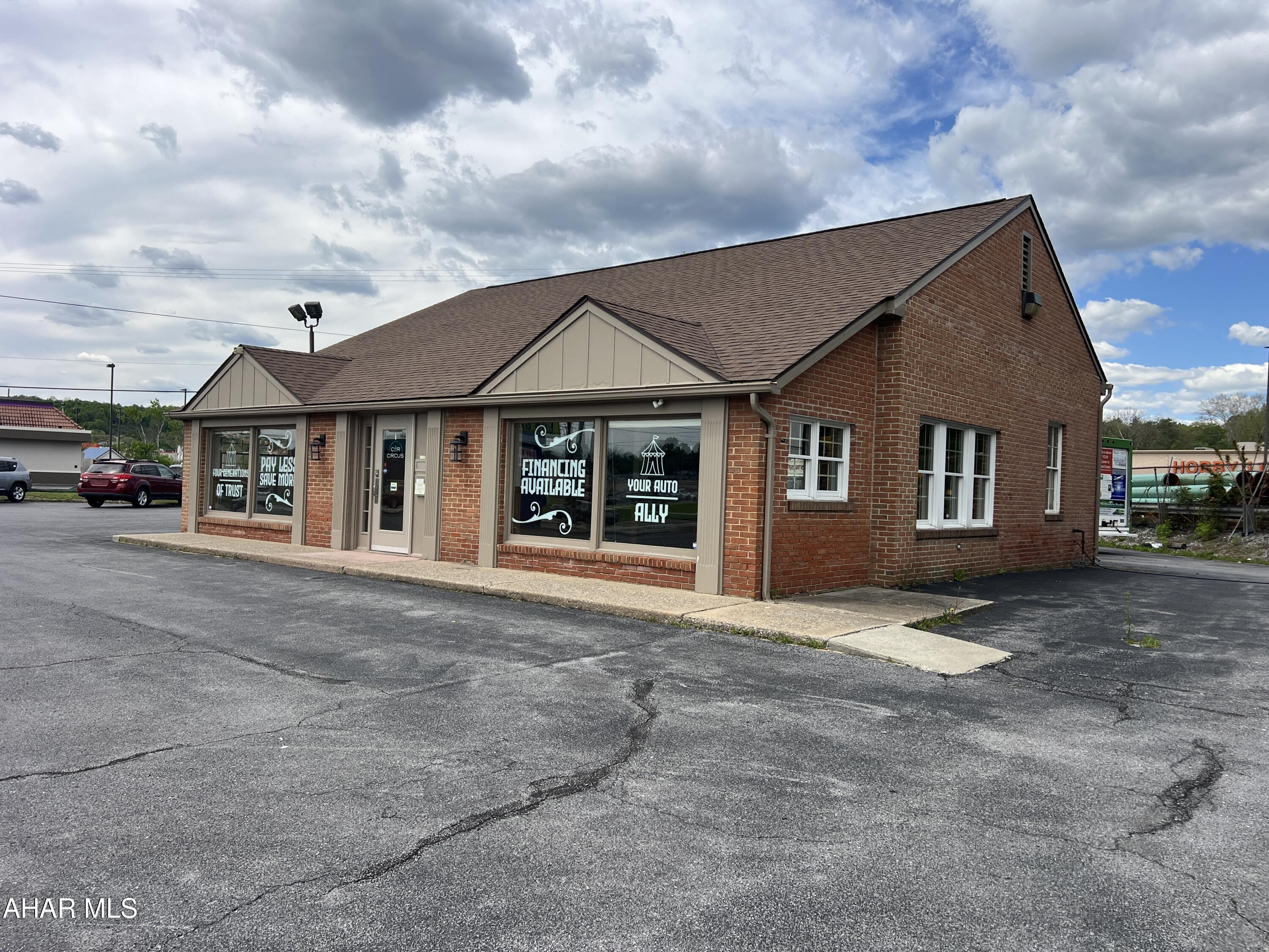 Prime commercial opportunity on one of Altoona's busiest corridors! Highly visible corner lot located along heavily traveled W. Plank Road with traffic counts approaching 37,000+ vehicles per day. Formerly operated as a successful car dealership, this property features an approximately 1,612 SF brick commercial building with over 21,000 SF of paved parking/display area on approximately 0.53 acres. Existing drive-thru window with potential for second lane/window configuration. Well-lit lot with flood lights, large pylon signage, multiple curb cuts, and excellent ingress/egress. Surrounded by local businesses, national chain restaurants, retail, and service providers. Ideal for QSR, coffee shop, bank, pharmacy, medical office, retail showroom, professional office, or continued automotive use. Rare opportunity to secure a high-exposure commercial site in one of Blair County's premier retail corridors.