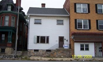 Commercial property in the city of Altoona, Upstairs tenant pays $500.  Downstairs needs to be renovated. 2nd floor is rented on a month-to-month lease for $500/month.  Downstairs needs to be remodeled.  It could also bring $500/month.  Owner pays heat & water.  New Roof in 2007.  Fence added in back yard in 2009.  Gas hot water heat. One refrigerator, 2 stoves included.  Upstairs 2 bedroom apt, Downstairs 3 bedroom apt or business.
