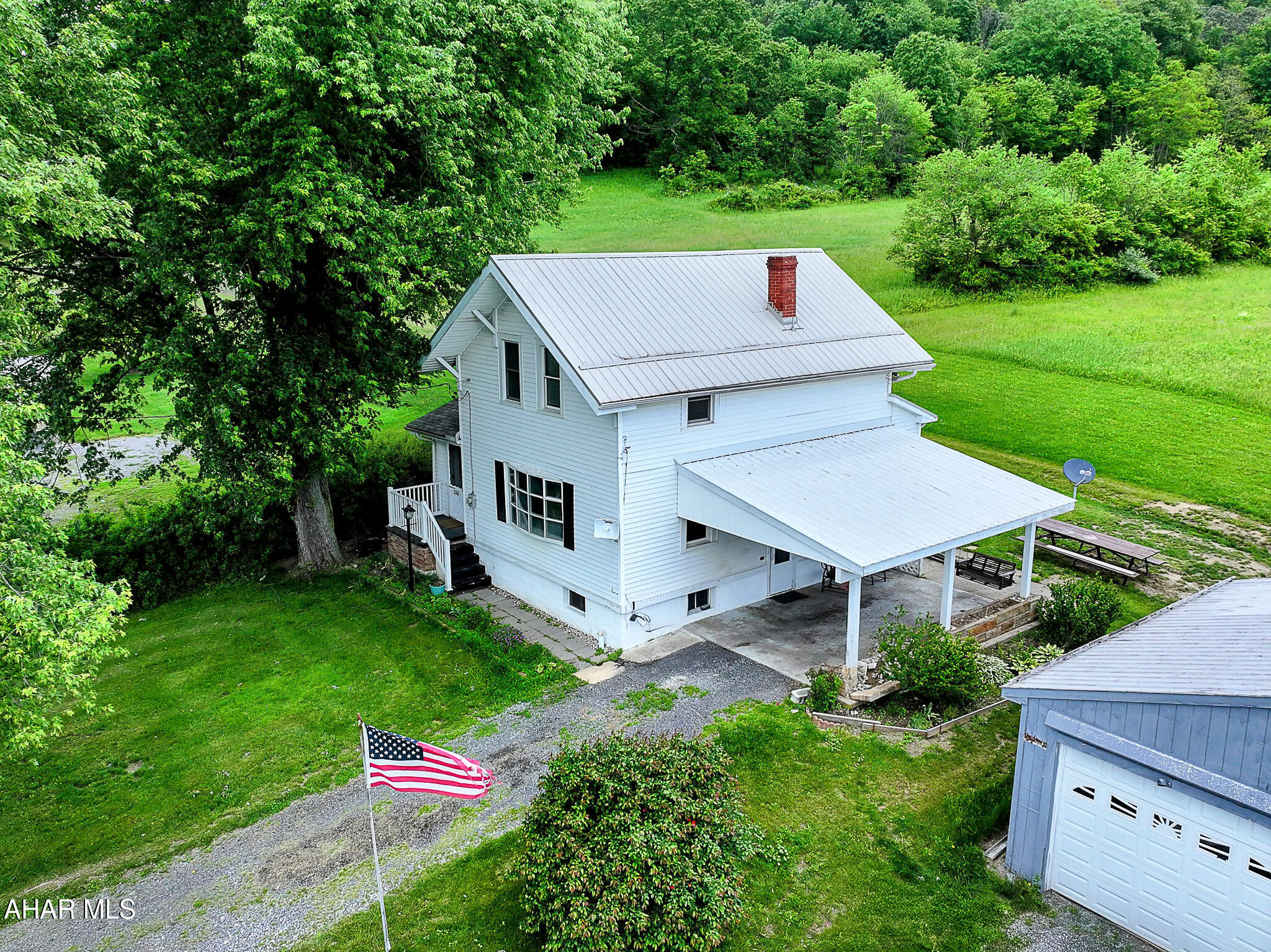 Huge PRICE Reduction ! This house is all about the lovely mountain views! Has a double lot, extra lot has some fruit trees and space for a large lush garden. Home has a small kitchen, dining room, living room , foyer with wood burning stove and half bath which has the laundry area.  All orginal hardwood floors in the living room and dining room. Upstairs there are three bedrooms and a bathroom with a tub. Seller currently heats with the woodstove, but the home also has hot water oil heat.  Outside nice size detached garage and separate shed. Public Water and Sewer. Just mnutes form I-99 for an easy commute. Call to take a look.