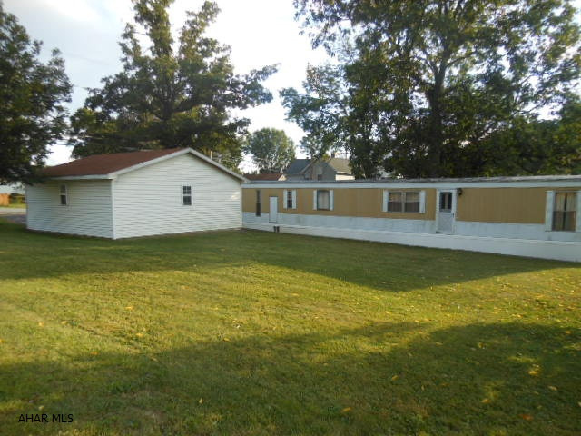Older singlewide with nice 2 car 24x24 garage on nice corner lot in Lakemont. Concrete slab for a shed. Garage has 100 amp service, 110 for compressor.