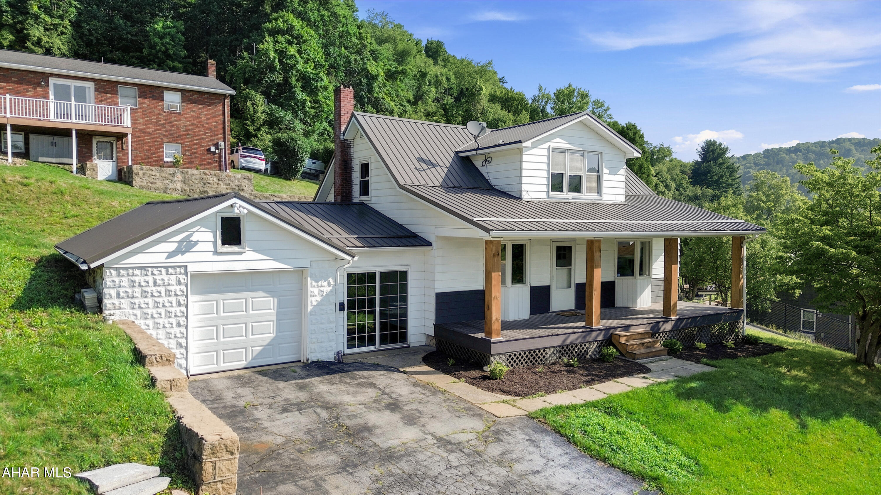 Welcome to 301 Hickory Street in the Northern Cambria School District! Perched on a corner lot overlooking town, this recently remodeled home offers a wonderful blend of modern updates and everyday comfort. The main floor features a spacious foyer, a bright and inviting living room, an updated kitchen complete with brand-new appliances, a beautifully renovated full bathroom, and a convenient first-floor bedroom. Upstairs, you'll find two generously sized bedrooms, each with charming attic cubby storage. The unfinished basement provides excellent storage space and houses the laundry area. Outside, enjoy the attached one-car garage, enclosed breezeway, welcoming covered front porch, expansive rear patio perfect for entertaining, and additional off-street parking. This move-in-ready home has so much to offer. Schedule your private showing today!