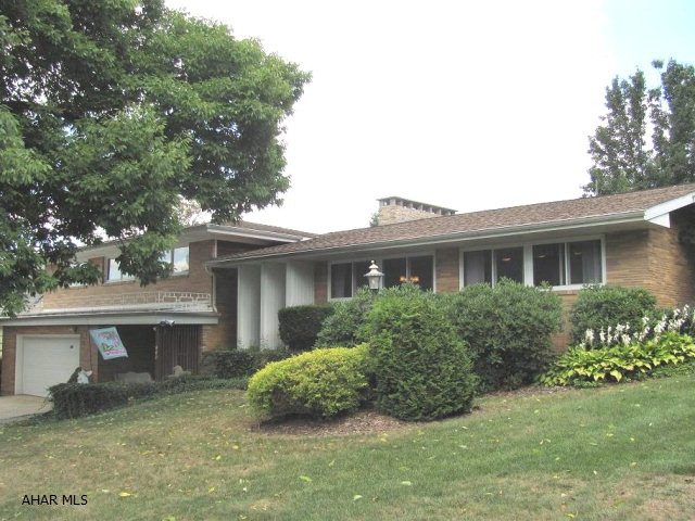 Ebensburg- Large 4 BR multi-level brick home featuring large LR w/ fireplace, den w/fireplace, FR, Large eat-in kitchen, office w/ built-in book cases, 2 1/2 baths. 2 car attached garage, security system, private well landscaped lot. Many extras.