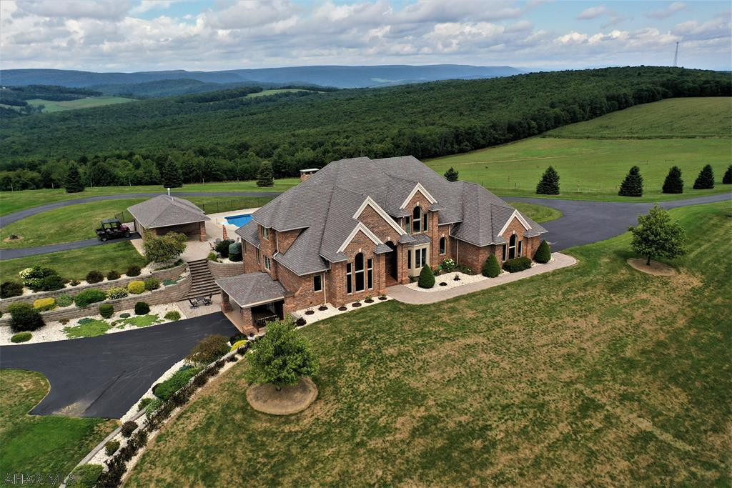 Absolutely stunning property resting on 225 acres & offering some 40-mile views of the countryside! Excellent quality w/ no expense spared in this build. All brick exterior construction, 2-story foyer w/ custom curbed oak staircase; 3-coat plaster ceilings & walls with skip trial finishing; Brazilian cherry, marble & granite floors; & geothermal heating & cooling (zoned). Solid panel wood doors; over sized thermo pane windows; & all custom built wood trim for windows & doors. Large brick entry pillars w/ security gates & bronze eagles leading up the 1/2 mile paved driveway; deco house pillars capped w/ granite slabs; 20'x40' in-ground/heated pool; brick pool house; paver patios & walks. Easy access to Pittsburgh, Somerset & major roads. Tour at:  https://www.youtube.com/watch?v=KBoF60oHArI