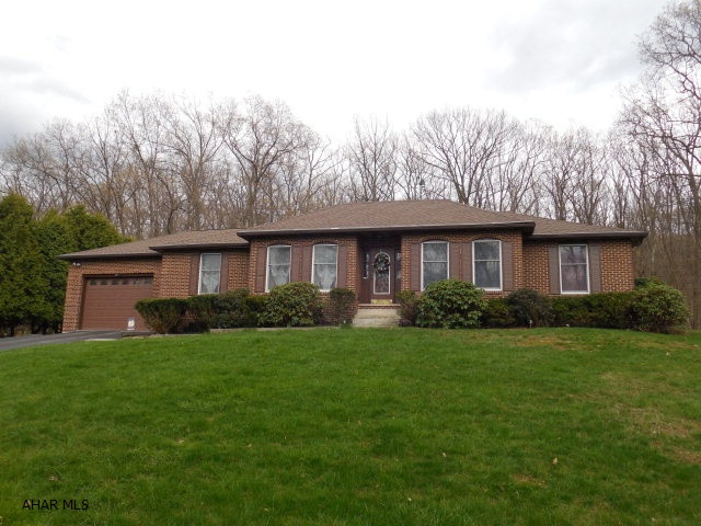 This home has such curb appeal. All brick rancher on a beautiful, wooded, private lot with an inground pool. Large trex deck and a charming pergola. Kitchen has been updated with maple cabinetry and hardwood floors. A cozy lst floor family rm with a stone fireplace and hardwood floors.  Off the family rm is a bright and cheery sunroom overlooking the pool area. A large finished lower level with a wet bar, 3/4 bath that was remodeled by bath fitters and a bonus rm that could be a 4th bedroom. A new roof was just put on. 3 zone hot water heat.  The grounds have been meticulously maintained and you have  total privacy in the backyard. Don't wait on this very special home.