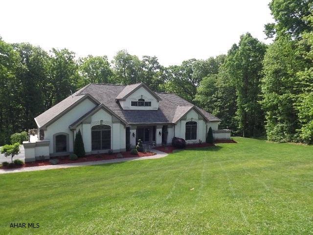 Spectacular energy-star certified builder's home situated on 1.49 wooded and private acres at the end of a cul-de-sac. Open concept in this split floor plan(2 master bedrooms) ranch with a full and finished lower level. Living areas on each floor capture the views from the 2-story wall of windows. Dining room boasts an open and airy 2 story ceiling. 34'x24' heated garage, combo and zoned heating. Solid oak throughout, 9' ceilings and open oak staircase to atrium.