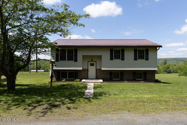 The well-maintained home offers 4 bedrooms plus a versatile bonus room that could serve as a 5th bedroom, home office, or extra storage space. The inviting family room features a stunning floor-to-ceiling stone fireplace with propane insert, creating the perfect cozy gathering space. Outside, enjoy 1.2 acres of yard space with plenty of room to relax, entertain, or play, along with a 2-car garage for added convenience. (Please NO drive-bys. Showings by appointment only.)