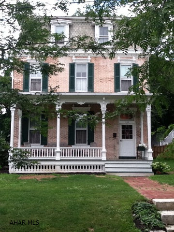 One of a kind jewel in the heart historic Bedford.  The Victorian architecture on the outside leads to an amazing large foyer flanked by an exposed interior brick wall next to the incredible grand staircase. The main floor commands an exceptional living and dining room that shares a middle brick wall with fireplace. The second floor is dedicated to a large master suite with 10' ceilings that includes a charming sitting room. A large eat-in kitchen leads out onto a delightful porch and peaceful backyard. Large pole building. The home's exterior brick has been restored to its original beauty. The architecture throughout adds to the charm  of this elegant mansion.