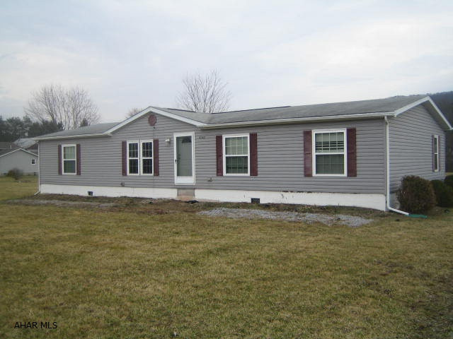 East Freedom double-wide property on half acre lot. Large living room, dining room, eat-in kitchen, 4 bedrooms, and 2 baths featuring large master suite. Vaulted ceilings and central air. Needs some work and being sold AS-IS.