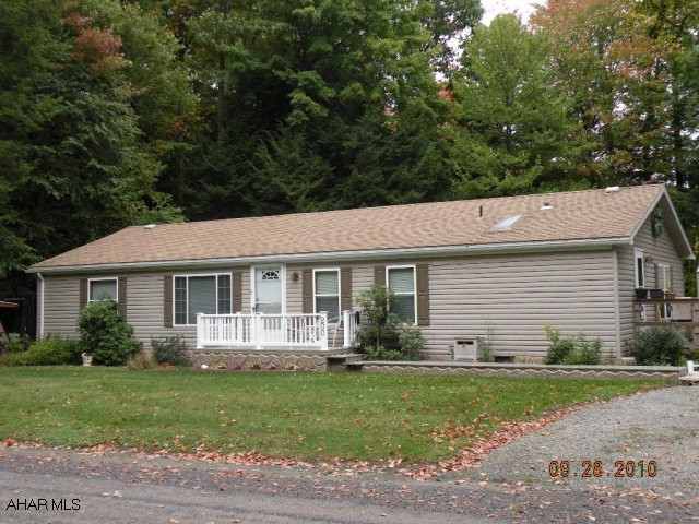 Attractive well maintained home, spacious and move in condition. Beautiful gas fireplace in family room, skylights, central air, carport, (12 x 20)shed, 12 x 12 rear deck, New 8 x 12 front porch, regulation horseshoe pit & camp fire area. Corner lot. Community swimming pool/ tennis courts/ Club house w/ kitchen Secure, private community for primary residence, retirement or vacation. Deed restrictions.