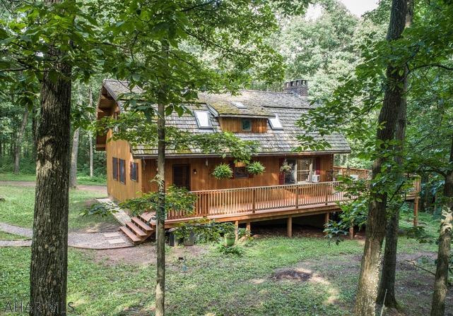 Surrounded by mature woods sits this custom cedar home perfectly situated on 22 secluded acres.  Inside, one feels as if they are sitting in an natural oasis as the interior cedar walls expand beyond through the many huge windows and large decks surrounded by everything nature.  A soaring brick floor to ceiling fireplace surrounded by glass adds a wow factor to the home.  Custom oak floors with cherry pegs, solid wood doors and cedar interior and exterior walls are just a few of the many outstanding features.  A 832 sq.ft. garage or workshop completes this property.  Click on visual tour to see drone footage.