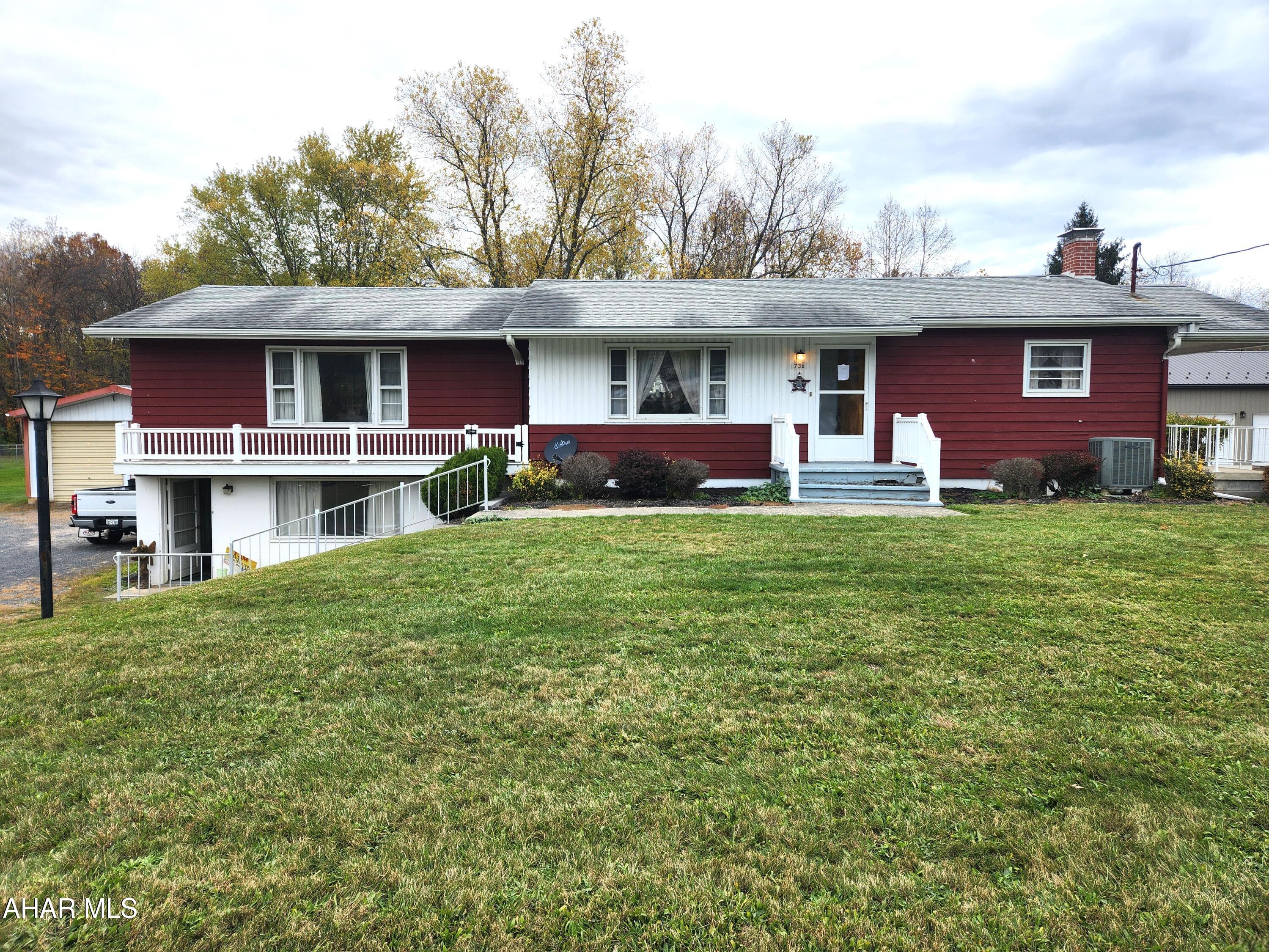 Hard to find ranch home in the Chestnut Ridge School District.  This 1,392 sf raised ranch offers 3 bedrooms, 2 bathrooms and sports a roof that was installed in 2023.  The galley kitchen features maple cabinets with pleanty of cabinet space.  The large dining room offers plenty of space for family dinners.  The spacious living room has an electric fireplace that provides both heat and ambiance.  Step outside from the living room to a large concrete deck above the two-car garage.  The main level bathroom features a walk-in shower.  The basement features a 528sf finished family area, a laundry area, a 3/4 bath with a tile shower, and a work shop area.  The attached two-car garage has an entrance door to the basement, making it nice to bring in your shopping items and not have to deal with inclement weather.  For those of you who need more garage space, the detached, 24 by 29, two-car garage is of steel construction.  It has a concerete floor, electricity and high garage doors.  The back yard is a great space for outdoor entertainment.  The house sits back from the road, resulting in a large front yard.  With a little paint and updated flooring this property will make a great home.  Located just a short distance from I-99 and the PA Turnpike, this home is in a central location to enjoy all that Bedford County and the surrounding area has to offer.  Come take a look today, it may be just what you've been looking for.  Buyer to verify acreage, square footage and flood zone.  Taxes do not reflect the Homestead Exemption.  Property is being sold ''as-is''.
