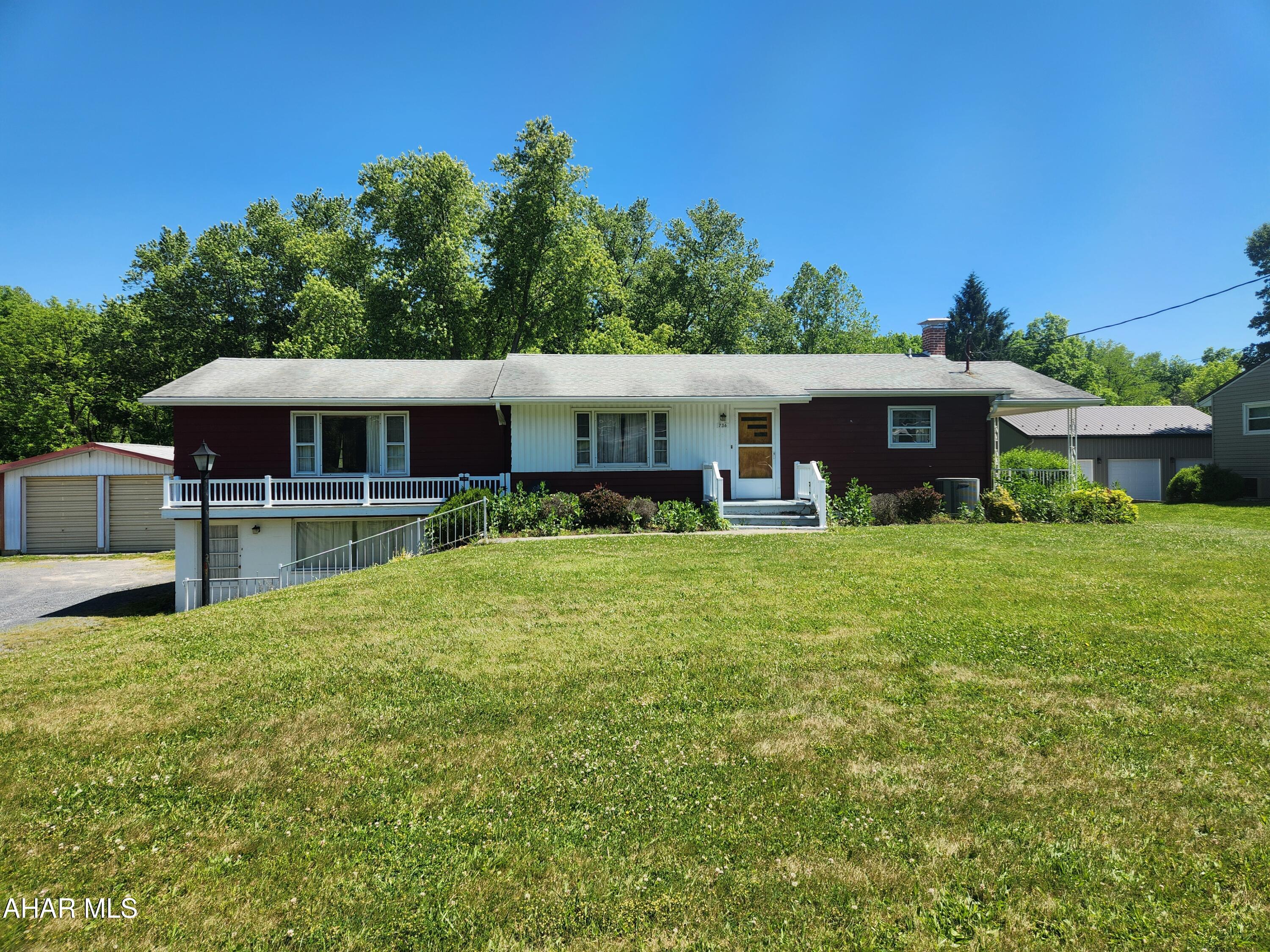 Hard to find ranch home in the Chestnut Ridge School District.  This 1,392 sf raised ranch offers 3 bedrooms, 2 bathrooms and sports a roof that was installed in 2023.  The galley kitchen features maple cabinets with pleanty of cabinet space.  The large dining room offers plenty of space for family dinners.  The spacious living room has an electric fireplace that provides both heat and ambiance.  Step outside from the living room to a large concrete deck above the two-car garage.  The main level bathroom features a walk-in shower.  The basement features a 528sf finished family area, a laundry area, a 3/4 bath with a tile shower, and a work shop area.  The attached two-car garage has an entrance door to the basement, making it nice to bring in your shopping items and not have to deal with inclement weather.  For those of you who need more garage space, the detached, 24 by 29, two-car garage is of steel construction.  It has a concerete floor, electricity and high garage doors.  The back yard is a great space for outdoor entertainment.  The house sits back from the road, resulting in a large front yard.  With a little paint and updated flooring this property will make a great home.  Located just a short distance from I-99 and the PA Turnpike, this home is in a central location to enjoy all that Bedford County and the surrounding area has to offer.  Come take a look today, it may be just what you've been looking for.  Buyer to verify acreage, square footage and flood zone.  Taxes do not reflect the Homestead Exemption.  Property is being sold ''as-is''.