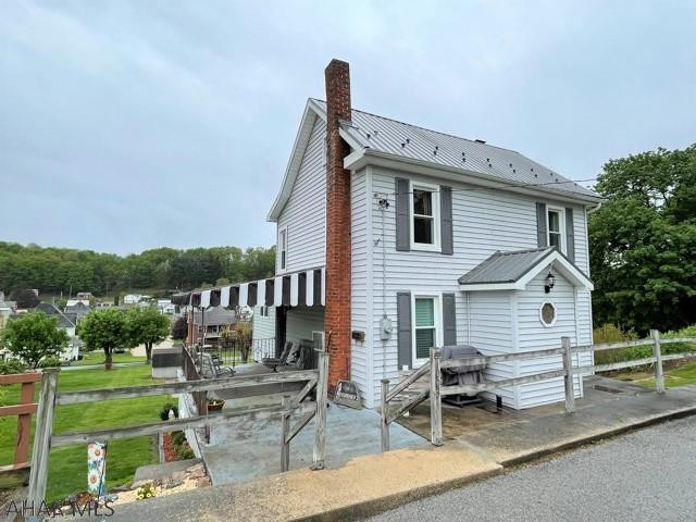 Very well maintained two-story home resting on a DOUBLE lot!! This home has been nicely updated & very well cared for. The main level offers a large LR, updated eat-in kitchen w/ center island & dining area, laundry & half bathroom. Second level has three bedrooms & a full bathroom. Hardwood floors, a walk-up attic that is great for storage & a full basement. Basement area is partially finished w/ a with bathroom, oil hot water heat, wood burning boiler, 200-amp electric & ground level walk-out. Side covered porch & side deck to enjoy some great views & relaxation. Updated metal roof, vinyl siding, & replacement windows. The double lot provides a large yard, garden area & off-street parking.