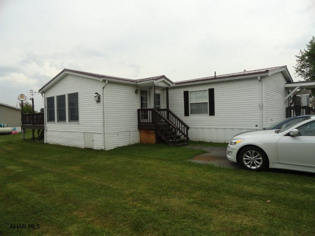 Nice double wide on rented lot in quiet Spring Drive Mobile Home Park next to Homewood Retirement Home in Martinsburg. Measured livable space of double wide is 52 x 26'. Large 20 x 14' Sunroom addition with knotty pine walls and cathedral ceiling with gas corner fireplace. Newer metal roof. Total square footage includes sunroom. Rear deck and shed. Lot rent only $180 includes garbage.