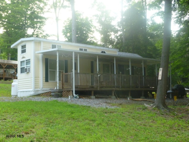 Bring the family because there is room for all.  Two bedrooms, a loft for the kids and additional sleep spaces allows up to ten people to comfortably sleep here.  The full length deck gives you room for enjoying the outdoors, even on those rainy days.  Situated on an oversized lot you have extra room for parking or outdoor fun.  Full size appliances take the roughing it out of your camping experience.  Double pane windows and a special winterizing package means you will be cozy using this property year round. Enjoy the amenities of Glendale Yearound - community pool, tennis/basketball/volleyball courts, planned activities for the whole family and don't forget Poochie Park where Fido can run free.  Glendale Lake and Rock Run ATV Park are not far away.  The good times are about to start.
