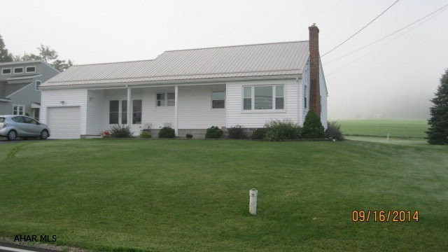 Refurbished two bedroom ranch with HW floor, Living room fireplace, and enclosed 3 season porch.  Hot water heat.