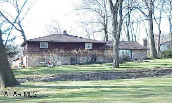 Nice Stone & cedar split level on Frankstown Rd. Beautiful lot w/ stream, 2 stone fireplaces in LR & family room. Call office for special Sales Agreement, copies of inspection reports and special addendums.