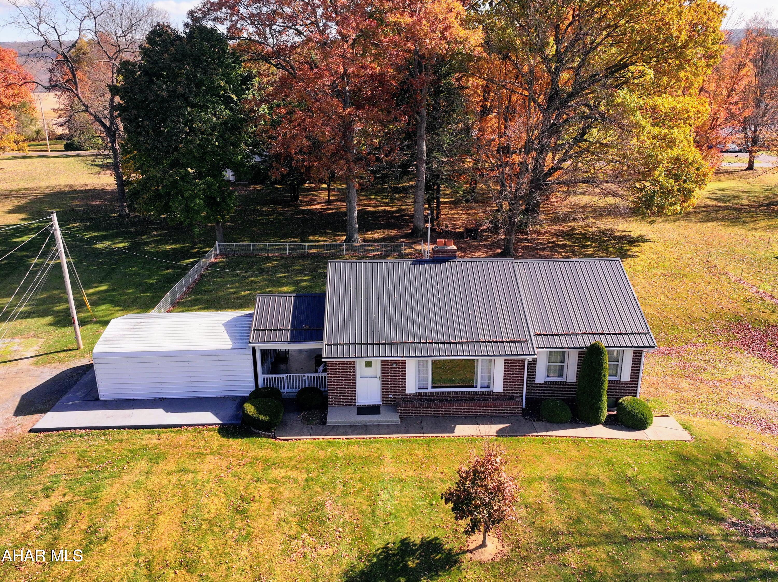 Full Brick Ranch located in a very accessible and conveinient location. Home is fully furnished and all furniture is included.  Carport leads to the newly epoxyed porch/patio. Fenced area in the back for children or small pets. Has so much potential from finishing the basement for a large inviting family room, to adding a 2 car garage with a primary suite above. Or just enjoy the move in ready home as it currently is. Heat is Oil F/A and also has Central Air. Don't let this one pass you by.