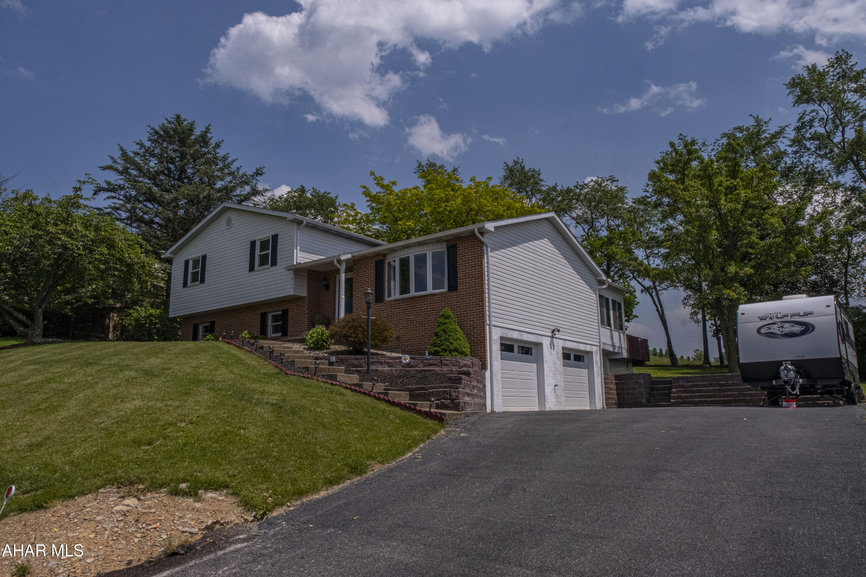 MOVE- in READY, with major upgrades and serene backyard views—all in the sought-after Hollidaysburg School District! This beautifully updated home features a new roof and hot water heater (2024), a full UV well water filtration system (2023), new carpets, fresh paint, stylish light fixtures, and brand-new garage doors. Step outside and take in the amazing open land view—a peaceful, private backdrop perfect for relaxing evenings or entertaining. The recently serviced hot tub with a new cover offers the perfect spot to unwind. Pet lovers will appreciate the invisible fence system, making it easy to let your dog roam safely. This home blends thoughtful upgrades with tranquil outdoor living.