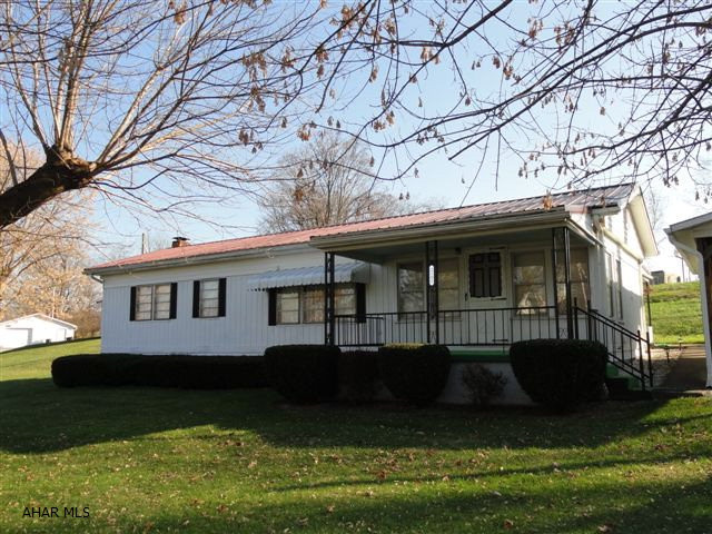 Own this pristine Williamsburg doublewide; on full foundation and delightful 1/2 acre lot.  Covered carport; 3 bedroom, 1 bath, first floor laundry, large 20x18 living room, eat-in kitchen/dining room, sunroom/den, finished family room in basement.  Ceiling fans in all bedrooms and dining area.  Extra shower in basement; basement also has two large storage rooms w/ walk-out.  12x16 garden shed; large front porch, rear covered patio.  Newer 35 year warranty metal roof/snow guards, furnace, water heater and water conditioner.  Don't miss this charming rural home!!! All this and in move-in condition.  Deeded property.