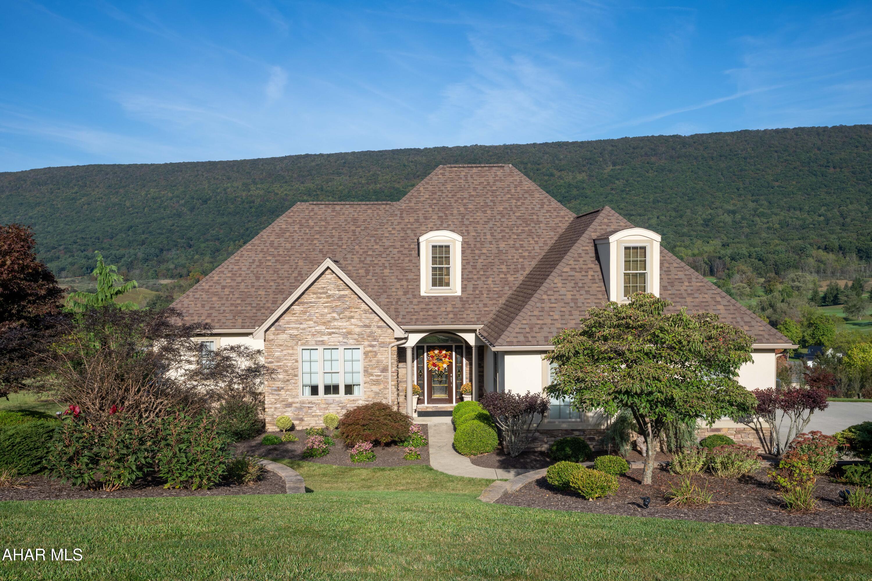 Majestic home in Scotch Valley with tremendous views. 5 Bedroom 4 1/2 Bath traditional home in Fairway Estates. Hardwood floors throughout main level with tile. Kitchen has quartz counter tops. Bonus Room off Kitchen. Lower level has 2 Bedrooms and 2 Baths, luxury vinyl flooring, Family Room with wet bar. Walk out to the patio with great view. Oversized garage. Huge storage area, 3 zoned heat pumps. New roof 2023.