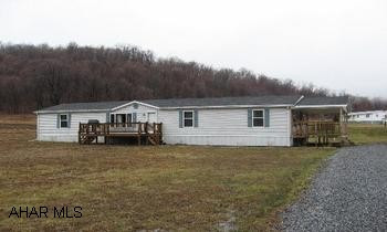 Deluxe 4 BR, 2 bath, doublewide home on 1.166 acres.  Located in Cooks Village. This home has a large covered porch (10x23) and front deck (10x16) for relaxing and entertaining. Contact Chris Bollman at 814-215-0017 for more information.