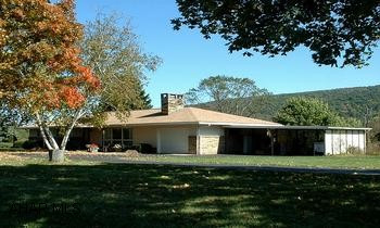Stone and Vinyl 3BR/1full and 1 3/4 bath ranch home. Lovely well-maintained stone and vinyl 3BR/2BA ranch home with central air, OHW heat and partially finished walkout basement. Located 5 miles from downtown Bedford on a nice level lot with a variety of nice mature trees. Home features newer kitchen with oak cabinetry, MBR suite with full bath, LR with wood-burning fireplace and large family room with lots of windows to enjoy the views of the mountains. The basement offers a den with wood-burning fireplace, playroom, workshop and laundry area. Other amenities: attached garage and two-bay carport, circular paved driveway and a 16x14 storage shed.