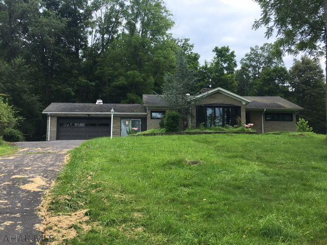 Ranch in private setting on more than 2 acres yet very close to town. Hardwood floors, 2 car garage, stone exterior. New roof. Excellent price. Being sold AS-IS.