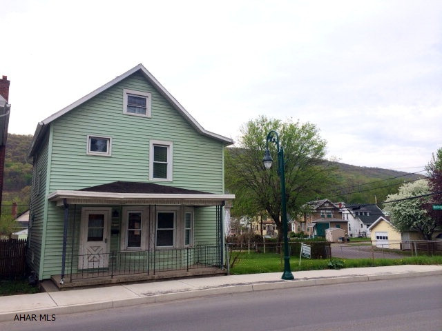 This charming 3BR/1BA home in Tyrone Area School District on a corner lot is a must see. With some TLC, this home has so much potential! Hardwood floors in both the Dining & Living Room. Beautiful unique original woodwork staircase. Spacious bedrooms. Walk up attic that boasts storage space. Large fenced in yard including a one car detached garage and additional off street parking. Newer windows throughout and back door.Super low flood insurance rates through Young Insurance ranging from $534.96($1,000 deductible) to $497.88($5,000 deductible)PER YEAR!