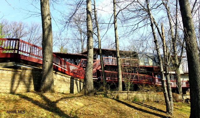 More than a home it's a lifestyle  California style cedar and brick Deck home located in the PA woods. Completely private. High ceilings with skylights, double decks, Beautiful family room and office in lower level 5 zone hot water heat, 2 separate air conditioning systems, heated pool, hot tub, separate bathhouse with full bath and kitchen. Three car garage.