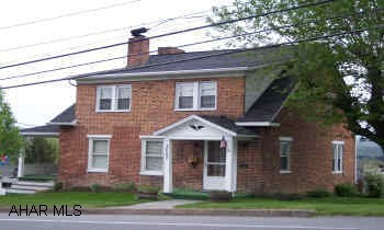 Well kept brick home features beautiful oak trim and hardwood floors large living room and fireplace with pellet stove insert