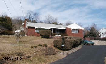One story brick rancher, 1 car basement garage. Good oak kitchen. 2 bedrooms, 1 bath, 2 fireplaces. Move in condition. Super location and lot.