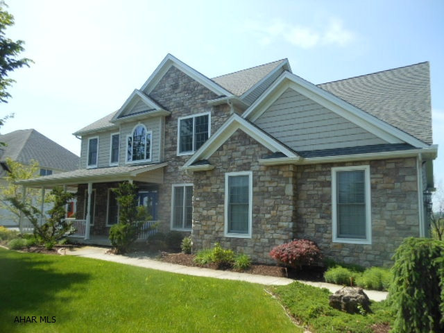 Absolutely lovely 5 bedroom 4 bath home on 0.9 ac lot in Fox Hollow. Enjoy the views from the wrap-around front porch or the relaxing back covered deck. Foyer w/ columns lead the way to the open family room /fireplace and kitchen w/ cherry cabinets, granite, SS app. and great eat-in area w/ bench and  bay window. Beautiful hardwood and tile floors. Main floor houses guest bedroom & bath, formal living room & dining room & private stairway to 2nd floor. Huge Master suite..tray ceilings, jacuzzi w/ wonderful arched window, walk-in closet.Great sized bedrooms, lots of walk-in closets, nice laundry room w/ skylight. Terrific lower level features exercise area, TV & sitting area, kitchen/granite and wet bar that opens to large patio . Great for entertaining and a game of basketball too !