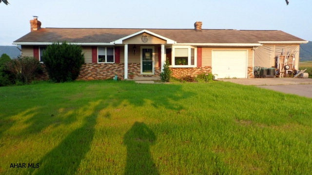 Country living minutes from town, Williamsburg 1.2 acres in Woodbury Twp. 6476 Clover Creek Road. One story with 3 bedrooms, 3 baths, living room, formal dining room, kitchen with breakfast bar, appliances, 1st floor laundry/pantry, semi-finished basement with walk-out, new public sewer, roughed in for 1/2 bath, deck, shed, fenced area, 1-car garage, 1-car carport, private drive...$139,900.