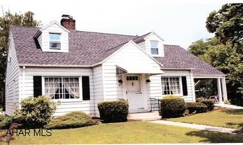Charming Cape Cod Home with many upgrades and amenities. Charming Cape Cod Home with many upgrades and amenities. Convenient in-town location. Foyer, DR with built-in corner cupboard, LR with fireplace, eat-in kitchen, master suite w/jacuzzi. Skylight, ceiling fans, beautiful hardwood floors. Lots of windows give this house a light and airy ambiance. Covered side porch, large back deck, private yard with flower beds, gazebo, white picket fence.  1-car integral garage and new detached 3-car garage, Home Warranty included.