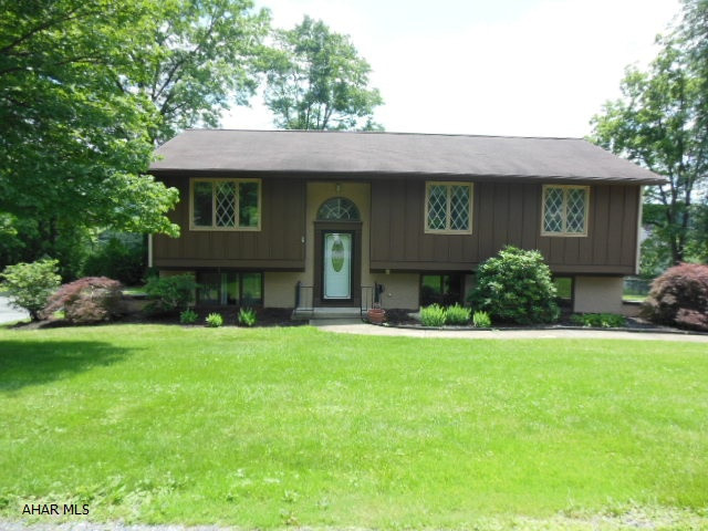 Very comfortable Bi level in Holiday Manor on a level lot! 3 bedrooms, 2.5 baths, family room with an efficient Harmon Pellet stove to compliment the zoned electric heat, central air conditioning heat pump. City water & sewage. Patio doors to a nice covered deck from the dining room (private). Large master bedroom with master bath, large garage with openers & some appliances. A Beautiful residential neighborhood - Make it you own!