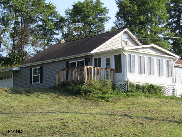 This ranch home on 2.27 acres(Parcels 52-09-40,49.1 & 39) is priced to sell! The house is completely renovated!! New siding,window,shutters,gutters & spouting, paint,drywall,insulation and garage doors. The interior has new kitchen cabinets, new carpet and new laminate. A new electrical panel and added new wiring and new plumbing where necessary to make this home MOVE IN READY! The garage has doors on both sides. The 3 season porch is bright and spacious for entertaining and enjoying the views. The owner also added an alternate source of fuel by adding a new wood burner in basement.