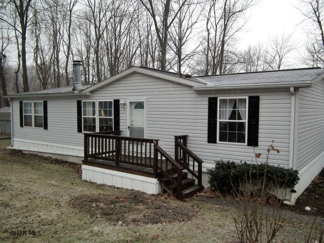 This well maintained doublewide is located in the Camelot Woods mobile park. Home has 3 bedrooms(walk-in closet in master), large spacious living room with beautiful stone fireplace. Cabinets and counter space is not a problem in this kitchen. Beautiful oak finish cabinets with showcase corner, breakfast bar + eating area off the kitchen. Screened in porch add to your enjoyment during those summer nights. 2017 Assess taxes reduced to $312.00.